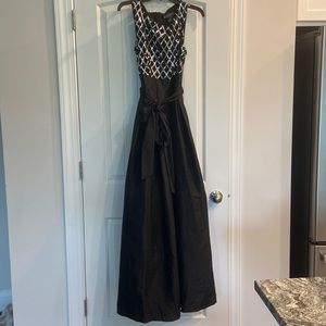 Floor length black dress with silver sequins on the top. It has pockets!